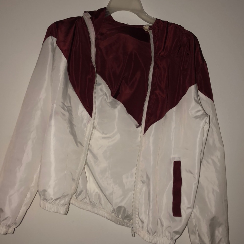 a maroon and white wind breaker!